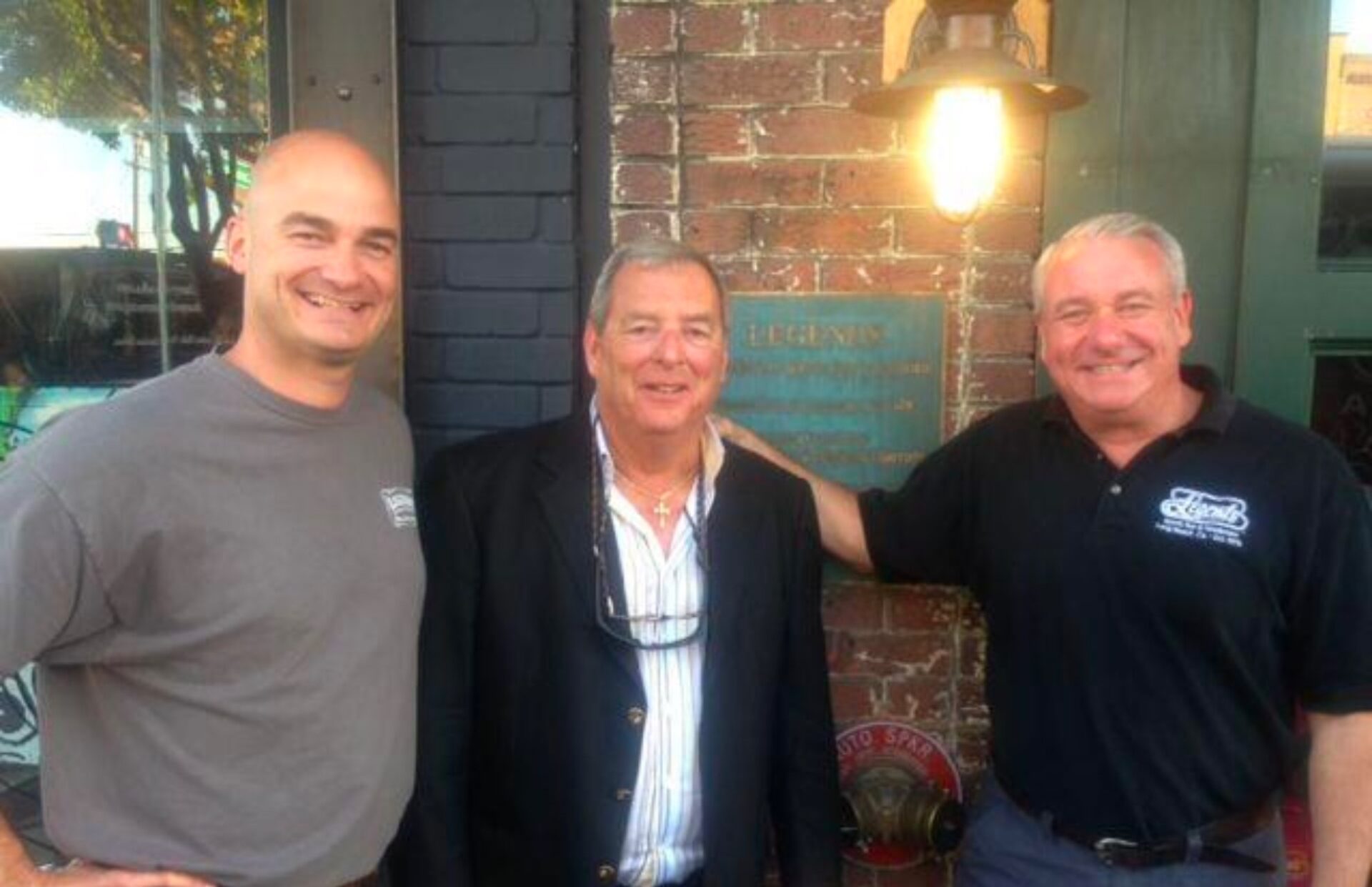Pictured here is Fuzzy Zoeller standing in front of Legends Sports bar with owners Matt and Eric